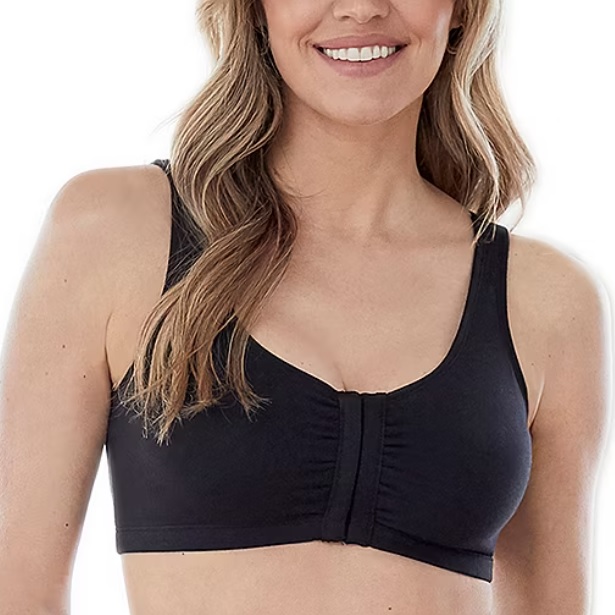 A woman wearing a black front-closure bra with wide straps and a scoop neckline, showcasing a comfortable and supportive fit.
