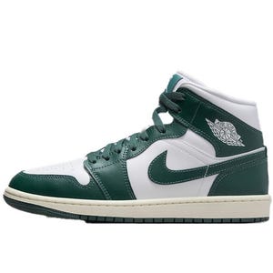 Nike Women's Air Jordan 1 Mid Shoes feature a classic high-top design with green leather overlays, white leather underlays, and the signature white Swoosh logo. The sneakers have a lace-up front, cushioned midsole, and the iconic Air Jordan wings logo on the side.