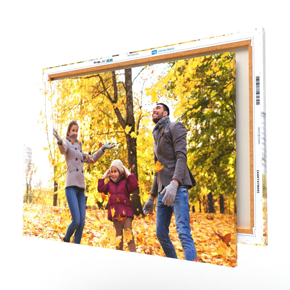 A canvas print featuring a family enjoying a walk in an autumnal park, with vivid yellow leaves on trees and ground.