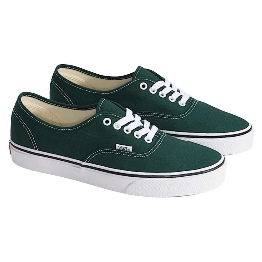 A pair of green Vans sneakers with white laces, featuring white stitching on the canvas upper and a white rubber sole with a black stripe.