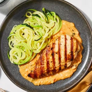 Grilled chicken breast with spiralized zucchini served on a creamy sauce.