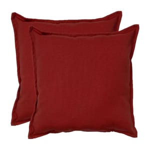 Two deep red square pillows with a simple, solid design and a slightly textured fabric surface.