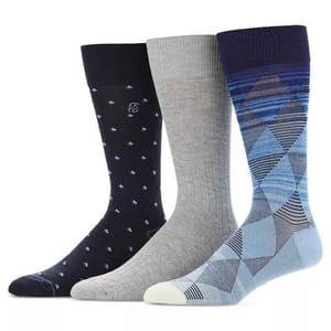 3-pack of Perry Ellis moisture-wicking socks featuring a black pair with small blue patterns, a light gray ribbed pair, and a blue argyle patterned pair, all with a ribbed cuff.
