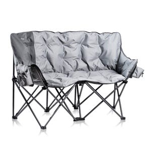 A foldable grey camping loveseat with a sturdy metal frame and cushioned fabric seat, featuring armrest pouches for storage.