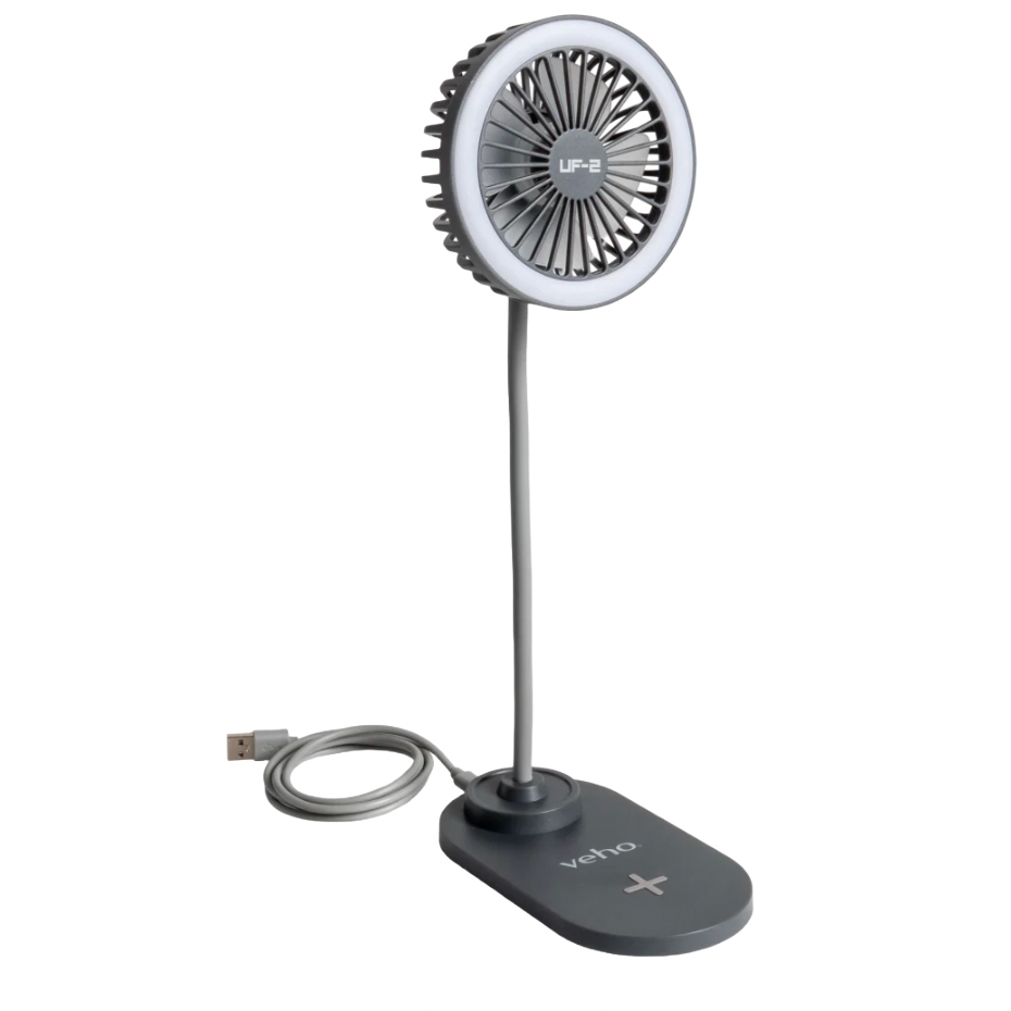 A USB-powered desk fan with a flexible neck and a circular design, featuring a central fan surrounded by a light ring. The base has \“veho\“ branding and a \“+\“ symbol.