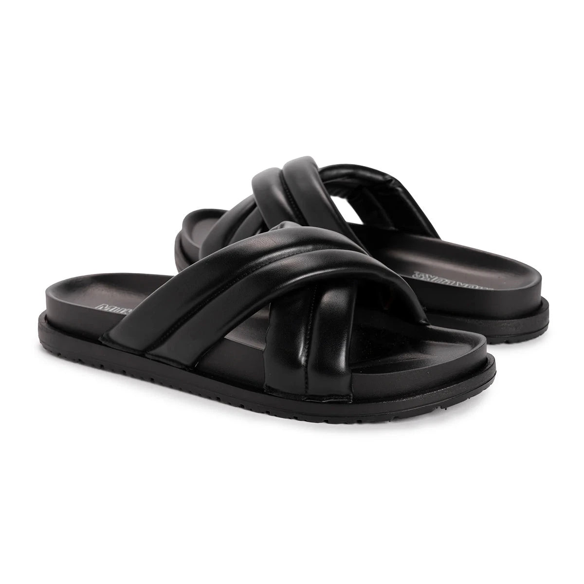 Black Muk Luks padded slides with thick crisscross straps and a flat sole.