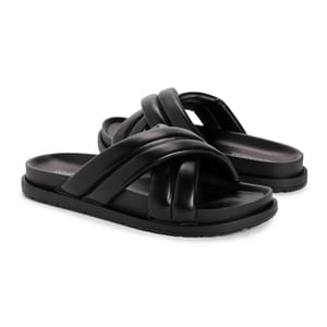 Black Muk Luks padded slides with thick crisscross straps and a flat sole.