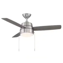 A modern ceiling fan with three blades, a central light fixture, and pull chains. The fan has a sleek, metallic finish.