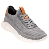 A gray knit sneaker with brown accents, featuring a white sole and lace-up design.