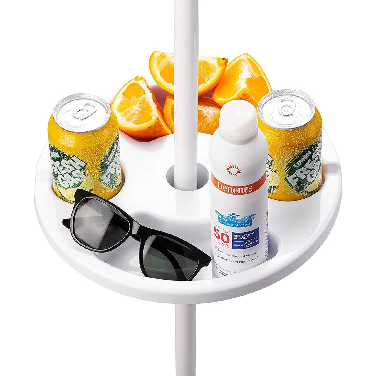 Round beach umbrella table tray holding two lemon-lime soda cans, sunglasses, a bottle of SPF 50 sunscreen, and orange slices.
