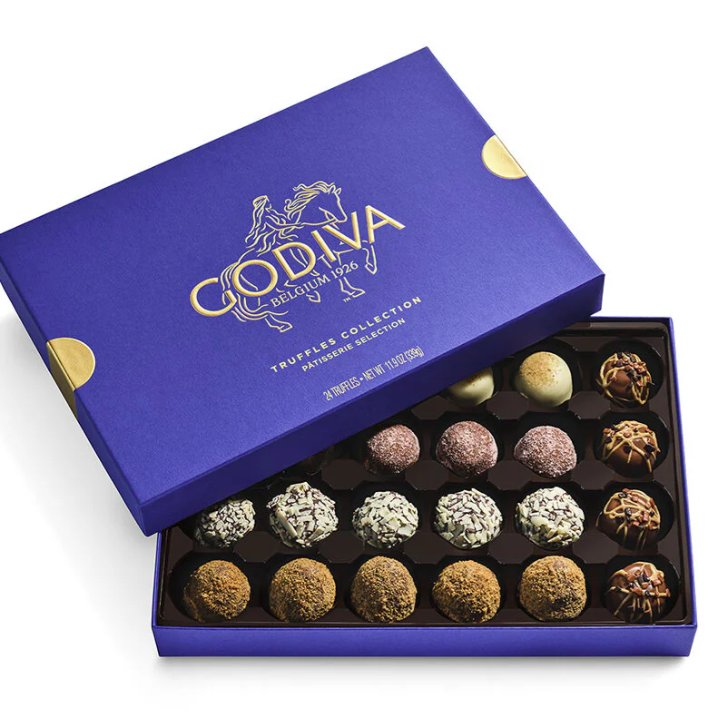 Godiva Patisserie Truffles Collection in a purple box, featuring an assortment of 24 chocolate truffles with various toppings and flavors.