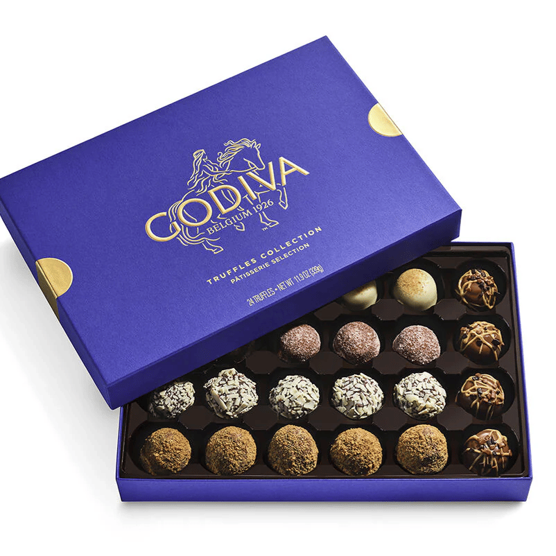 Godiva Patisserie Truffles Collection in a purple box, featuring an assortment of 24 chocolate truffles with various toppings and flavors.
