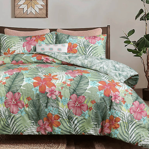 The Queen Summer Island Comforter Set features a vibrant tropical design with large pink and orange flowers, green leaves, and includes matching pillow shams. The bedding set adds a colorful, nature-inspired decor to the bedroom.