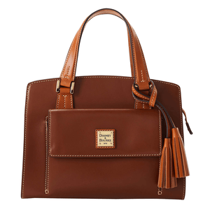 Brown leather satchel with gold hardware, dual top handles, an exterior pocket with logo plaque, tassel accents, white stitching, and a structured silhouette.