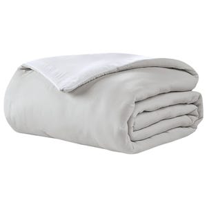 White reversible comforter with a smooth finish, featuring a simple and elegant design suitable for minimalist or modern bedrooms.