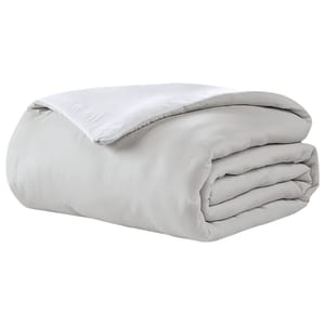 White reversible comforter with a smooth finish, featuring a simple and elegant design suitable for minimalist or modern bedrooms.