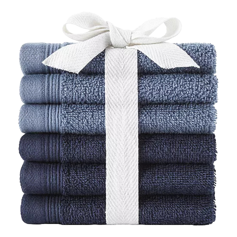 A stack of six blue towels tied with a white ribbon, featuring different shades ranging from light to dark.