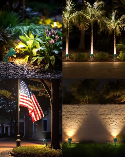 Outdoor landscape lighting illuminating plants, palm trees, an American flag, and a stone wall, creating nighttime ambiance.