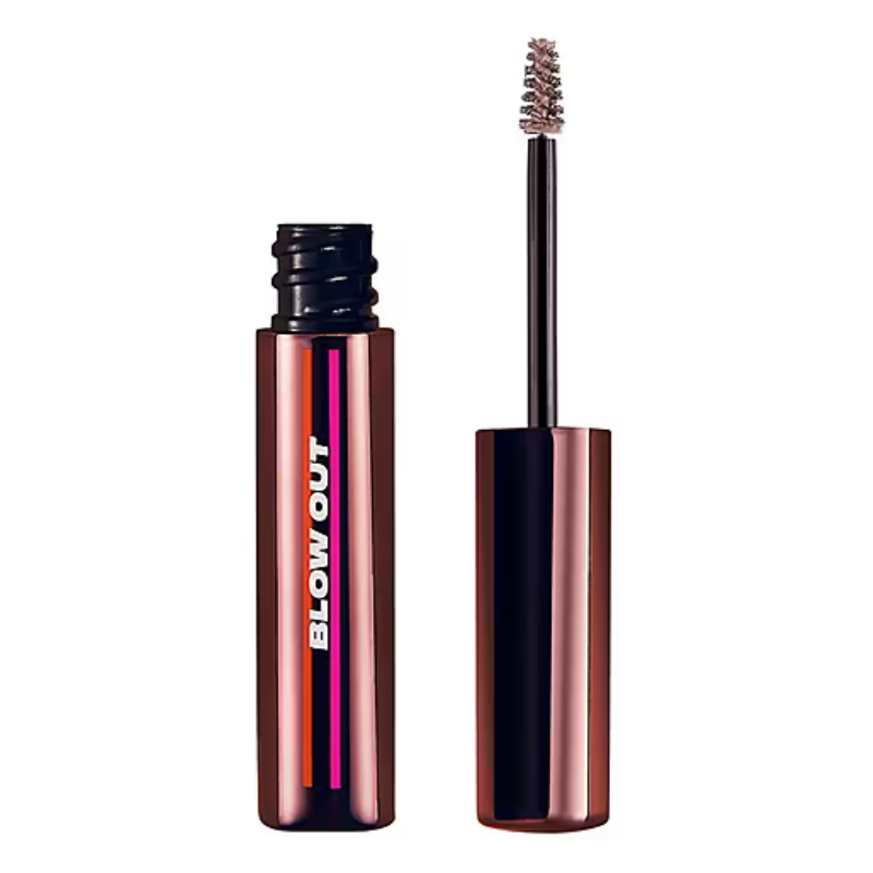 A tube of brow gel with the label \“BLOW OUT\“ and a brow brush applicator.