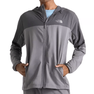 The North Face Mittellegi Jacket is a two-tone gray, lightweight zip-up with a hood, featuring The North Face logo on the chest and two side pockets.
