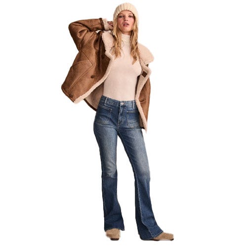 Lucky Brand Stevie Flare Jeans feature a mid-rise fit, flared legs, and a classic blue denim wash. They are styled with front and back pockets and offer a retro-inspired silhouette.