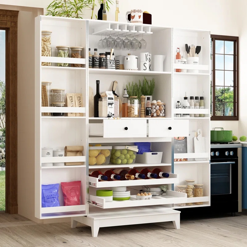 A spacious two-door white kitchen pantry with shelves and drawers, holding various jars, bottles, packaged goods, and hanging wine glasses. It also stores fruits, wine bottles, and kitchen essentials, offering organized and accessible storage.