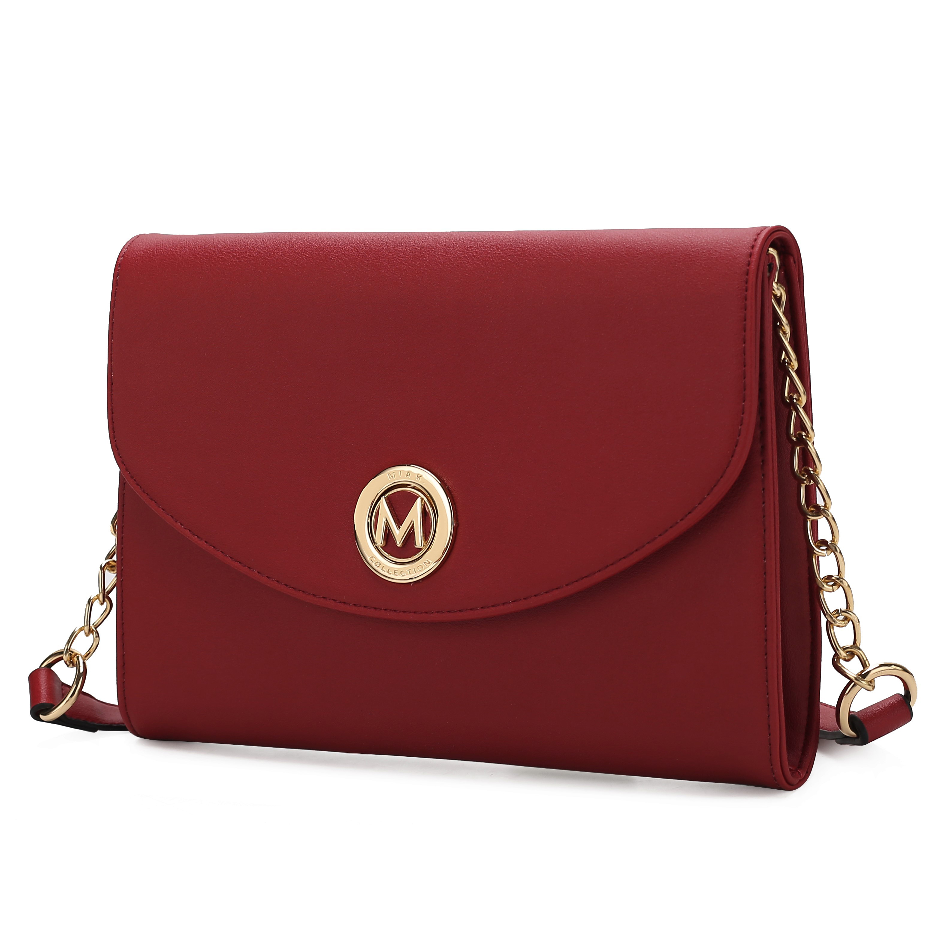 Red crossbody bag with a gold chain strap and a circular gold emblem featuring an \“M.\“