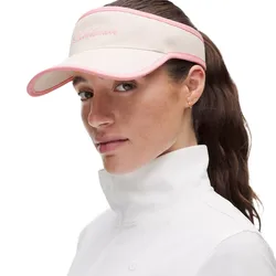 A woman wears a white and pink visor with embroidered text and a white jacket with a high collar.