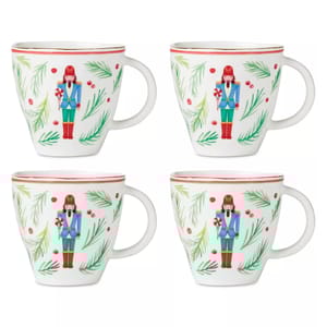 Set of four mugs featuring a nutcracker soldier design with festive green pine and red berry accents, each with a red rim.