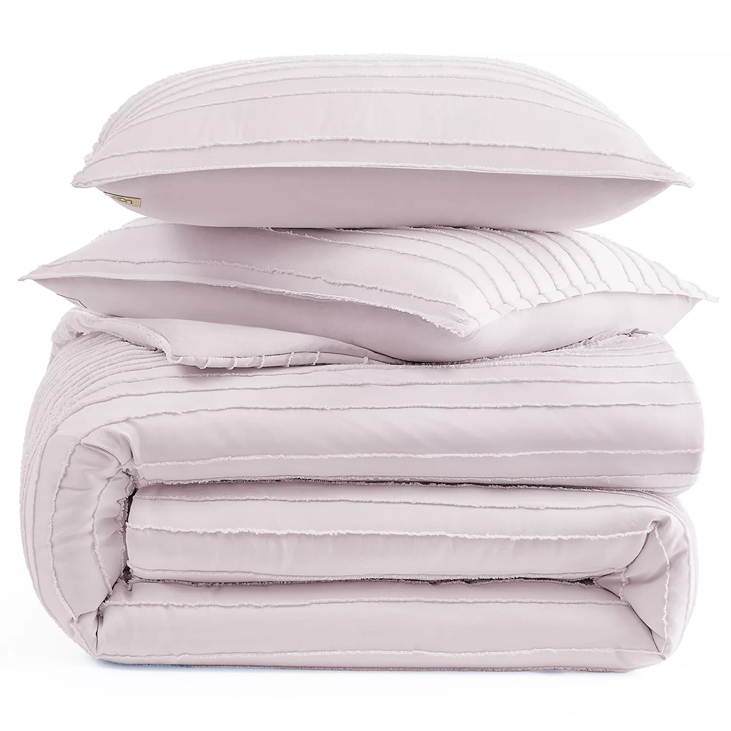 A stack of light pink, pleated bedding items, including two pillows and a folded comforter.