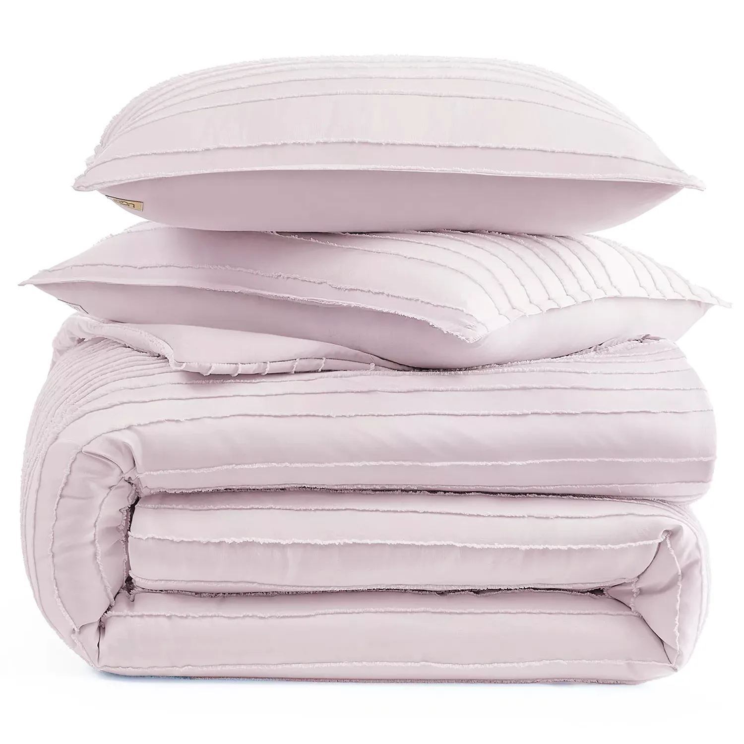 A stack of light pink, pleated bedding items, including two pillows and a folded comforter.