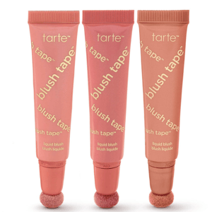 Three tubes of Tarte Blush Tape liquid blush with sponge applicators, in varying shades of pink and peach.