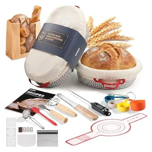 Bread-making kit featuring banneton baskets with liners, recipe book, bread scoring tool, whisk, bread lame, dough scraper, measuring cups, spoons, and a silicone baking mat.