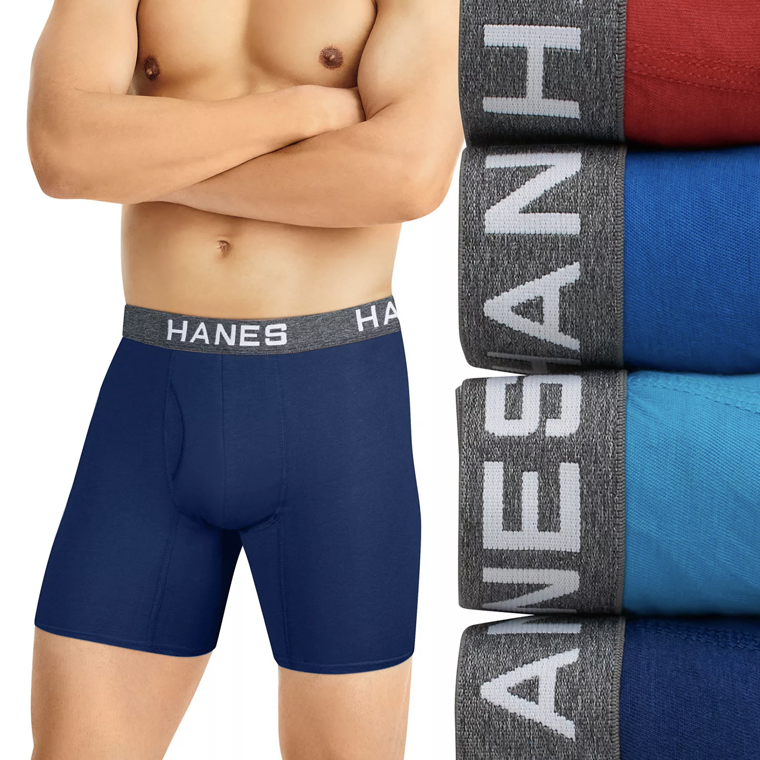 A man is wearing Hanes navy blue boxer briefs with a gray waistband, and there are additional pairs in red, blue, and light blue stacked beside him.