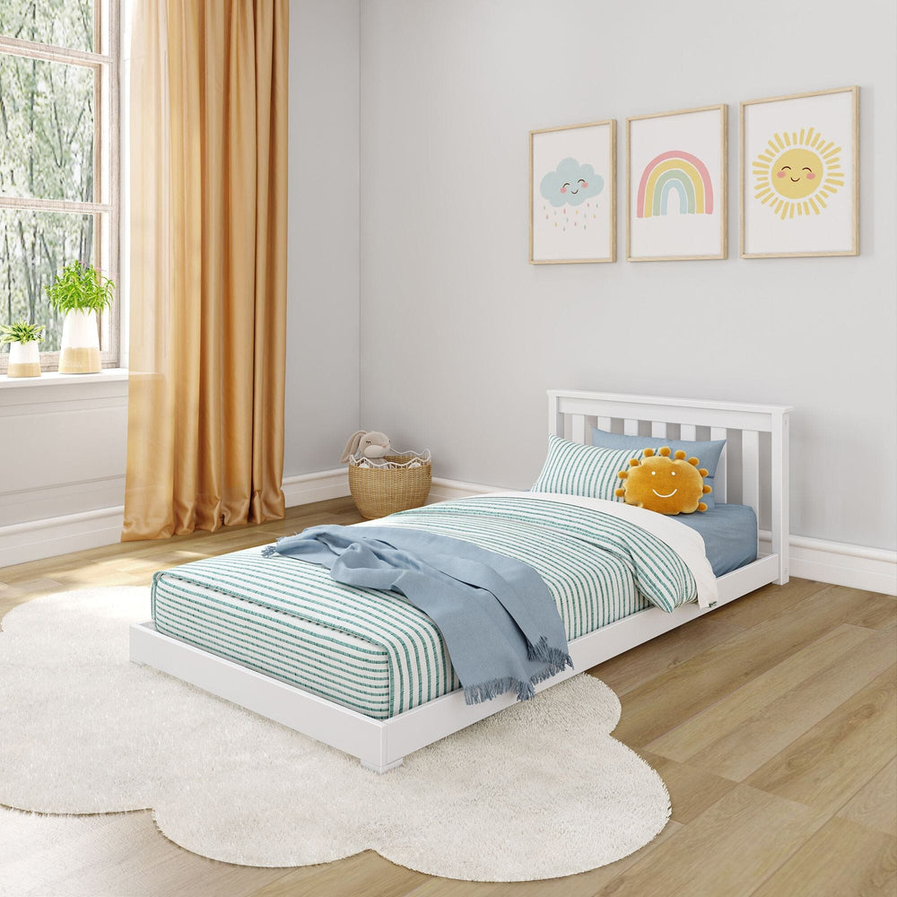 A white kids' twin floor bed frame with slatted headboard is shown. It features a blue and white striped bedding set with a sun-shaped pillow, and a light blue blanket draped over the bed.