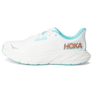 White HOKA running shoe with a turquoise interior lining and sole accents, featuring the HOKA logo on the side.