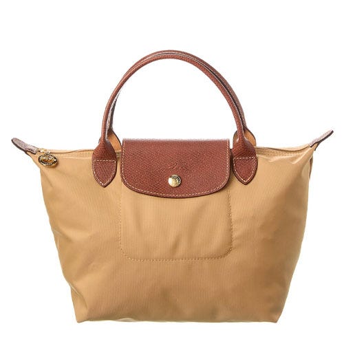 Tan nylon tote bag with brown leather handles and flap closure, featuring a gold button.