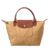 Tan nylon tote bag with brown leather handles and flap closure, featuring a gold button.