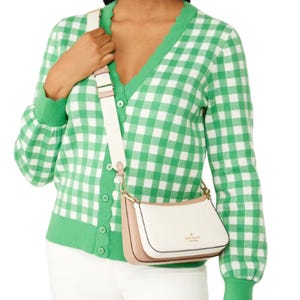 A green and white gingham cardigan paired with a white crossbody bag with a gold-tone logo.
