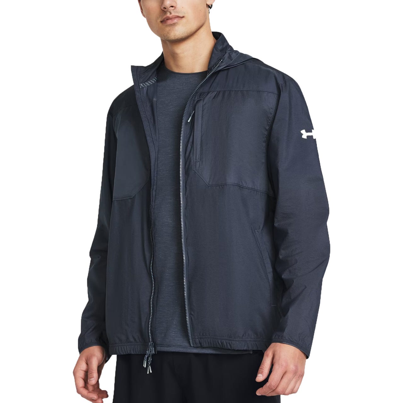 A man is wearing a dark gray Under Armour trail jacket with a zippered front, stand-up collar, and the Under Armour logo on the right chest.