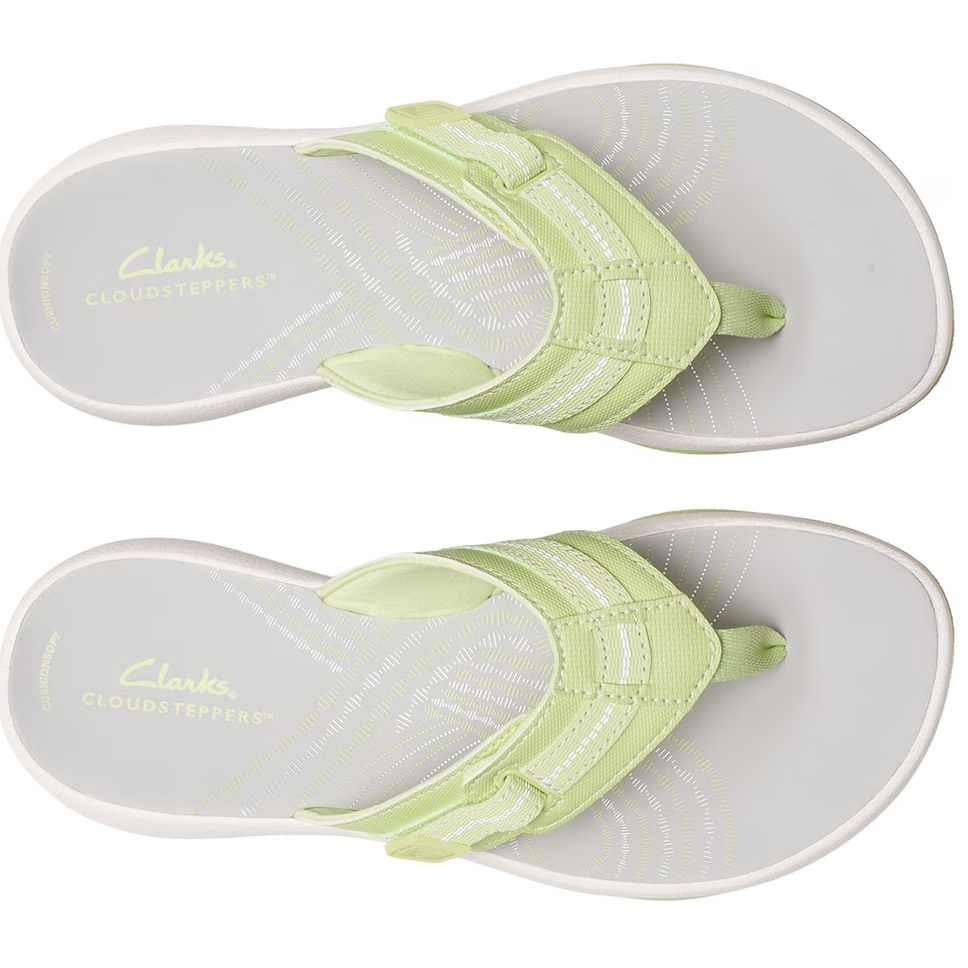 A pair of light green Clarks Cloudsteppers sandals with a toe loop and adjustable strap.