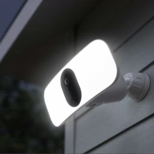 A wall-mounted outdoor security light with a built-in camera, featuring a bright, rectangular LED panel for illumination.