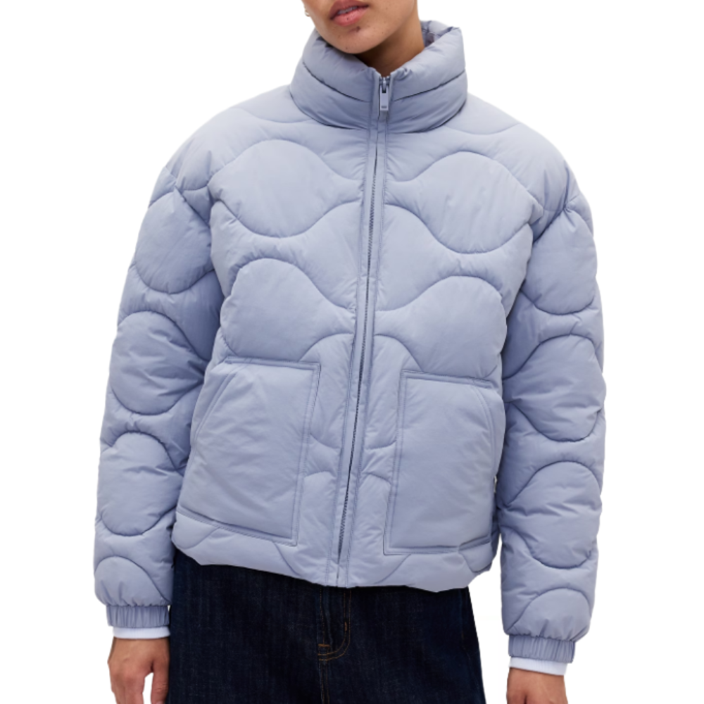 Light blue quilted puffer jacket with a wavy stitch pattern, featuring a high collar, front zipper, and two large front pockets.