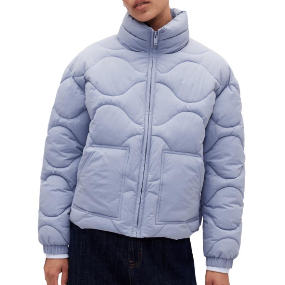 Light blue quilted puffer jacket with a wavy stitch pattern, featuring a high collar, front zipper, and two large front pockets.