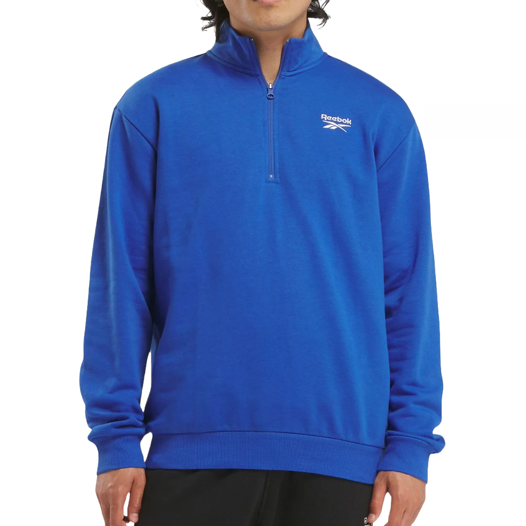 Blue Reebok quarter-zip pullover with a high collar, featuring the brand logo on the left chest. The pullover has long sleeves and ribbed cuffs for a comfortable fit.