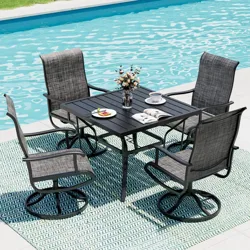 Outdoor patio set with a rectangular table and four swivel chairs by a pool, featuring textured fabric chairs, a black table, a striped rug, and tableware with a vase of flowers.