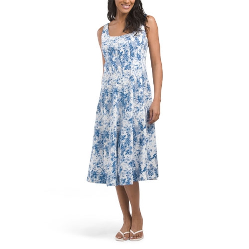 Blue and white A-line Nicole Miller midi dress featuring a sleeveless design with a subtle abstract pattern, slightly flared skirt, and a square neckline. The model is wearing white sandals for a casual look.