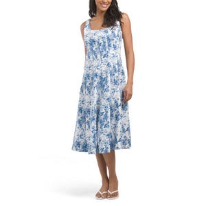 Blue and white A-line Nicole Miller midi dress featuring a sleeveless design with a subtle abstract pattern, slightly flared skirt, and a square neckline. The model is wearing white sandals for a casual look.