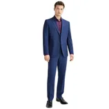 A man is wearing a blue suit with a dark purple shirt and black dress shoes. The outfit is formal and suitable for professional or special occasions.