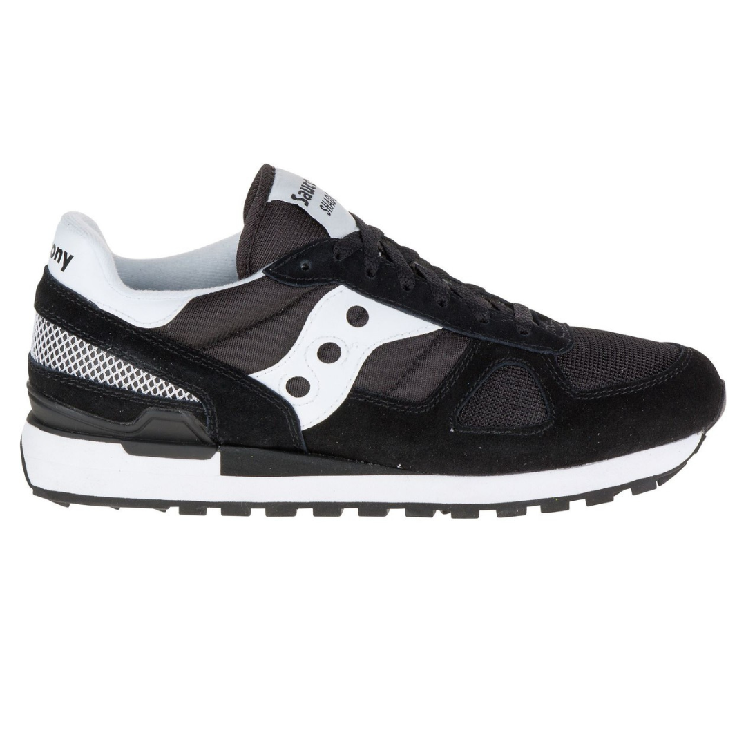 Black and white Saucony Shadow 5000 sneaker with mesh and suede elements, featuring the signature Saucony wave logo on the side.